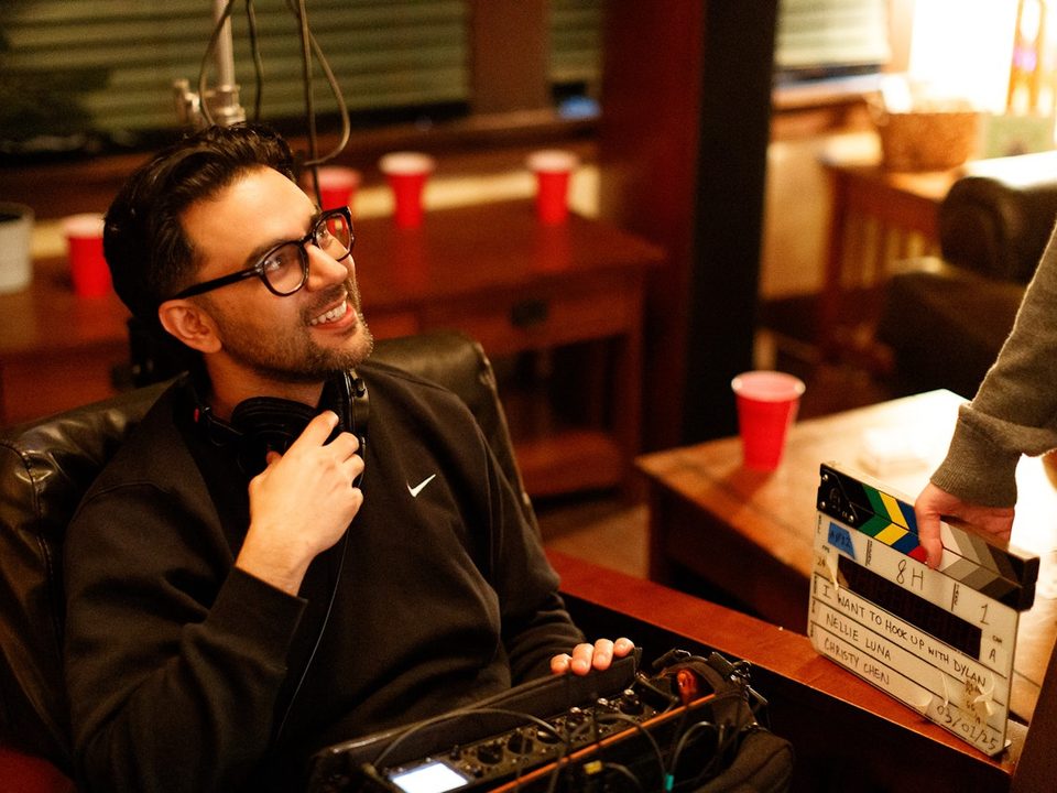 Rishi Kara on set, headphones around his neck
